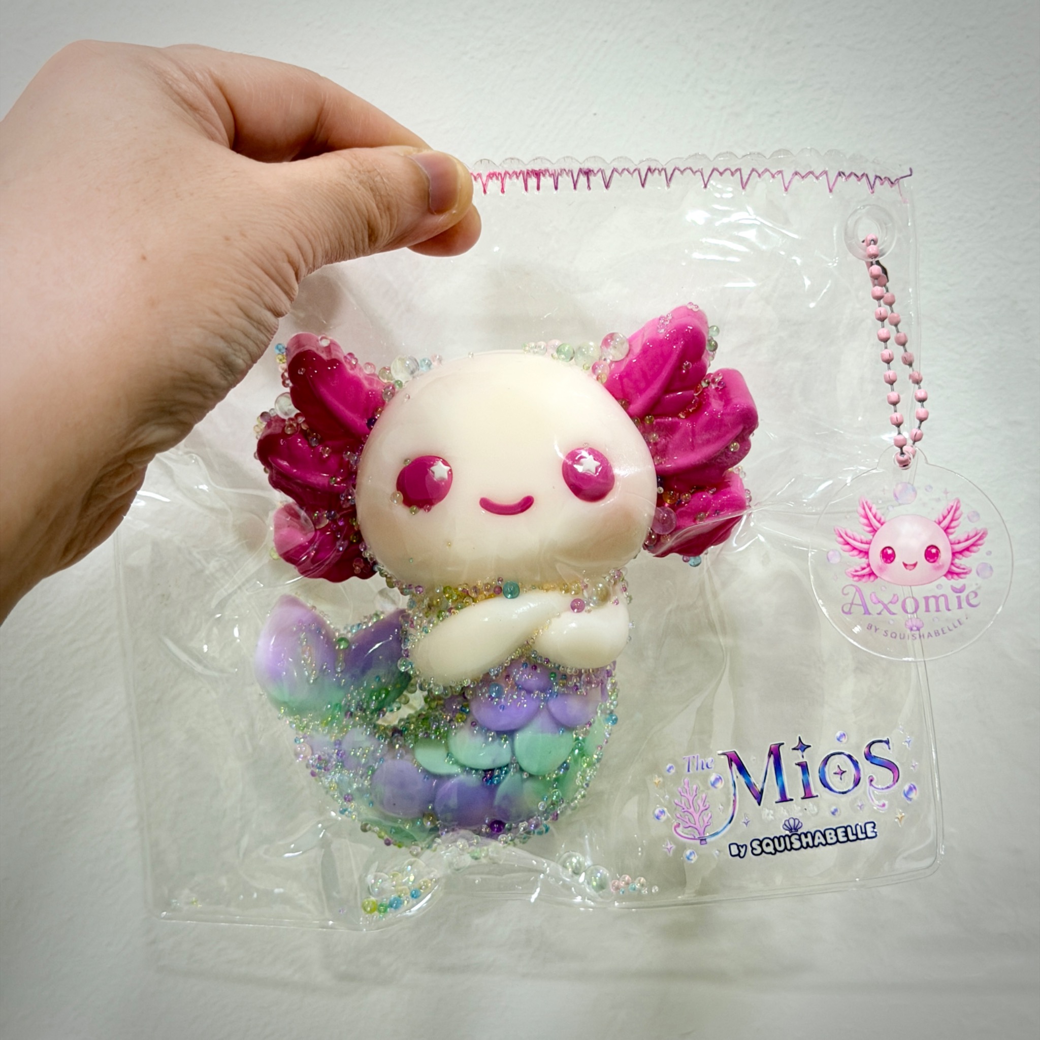 Axomie squishy in clear The Mios packaging held up for display